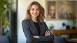 © Ceylon Frames - Portrait of successful confident pretty, young business woman or freelancer standing near work desk in office, arms crossed, looking at camera, smiling friendly generative ai