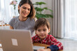 © Art_Photo - Mother helping young son with online learning on a laptop, homeschooling and education concept, woman and child spending quality time together, modern technology, digital education, family interaction