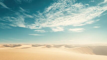 A sweeping view of a remote desert with endless dunes and a calm sky, ideal for copy space. No people