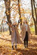 © prostooleh - Two girls friends spending time together in autumn park
