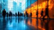© julija - dynamic long exposure shot of businesspeople in motion creating a blur of blue and orange streaks in a bright modern office lobby
