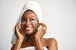 © prostooleh - Black girl with towel on a head has eye patches isolated on white background