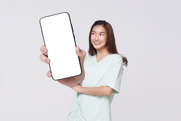 Happy Asian woman showing big mockup smartphone isolated on white background, application service life insurance and healthcare concept.