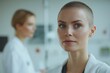 © YURY YUTY - Close-up of a focused doctor with short hair in a hospital setting, wearing a lab coat, with a colleague blurred in the background.
