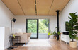 © Wavebreak Media - Modern living room with large windows, indoor plants, and minimalist furniture, copy space