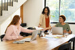 © Wavebreak Media - Collaborating on project, diverse women friends using laptops and sharing documents at table