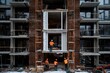 © Milos - Construction workers in orange safety gear working on the exterior of a modern apartment complex, utilizing scaffolding and tools to construct the multi-story building.