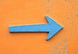 © Eva13186707 - Blue Arrow On Orange Wall - Direction & Success