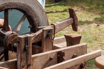 Old wooden hand-operated machine for dangling a hand scythe