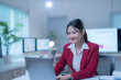 © Tj - Focused asian businesswoman working late on laptop in dimly lit office, exuding confidence and professionalism. Captures essence of driven entrepreneur in modern workplace