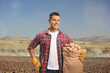 © Ljupco Smokovski - Young farmer holding potatoes in a sack