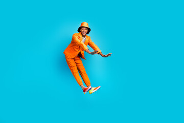 Sticker - Photo of stylish trendy guy jumping have fun wear glamour blazer pants isolated cyan color background