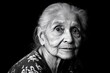 © Thanyarat - A black-and-white portrait of an elderly woman, her face showing deep lines and wrinkles, telling a story of wisdom and life experience