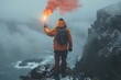© Matvejs - Distressed man on rocky island signals for help with red smoke bomb and torch against gray sky