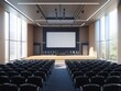 © Lucky_jl - Modern auditorium with rows of seats, a central stage, and large windows for natural light, ideal for presentations and events.