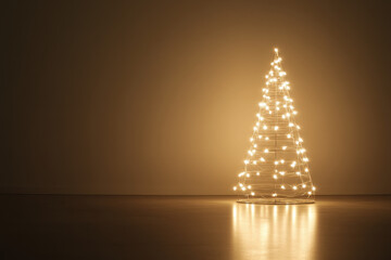 Wall Mural - modern christmas tree made of glowing fairy lights is standing in a dark room