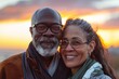 © CogniLens - Portrait of a satisfied multiethnic couple in their 50s enjoying a sunset together