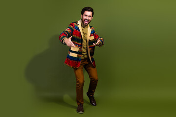 Wall Mural - Photo of positive funny nice man wear trendy clothes empty space isolated on khaki color background