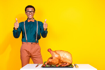 Canvas Print - Photo of positive guy make thumb up recommend tasty turkey for thanksgiving day isolated yellow color background