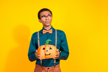 Wall Mural - Photo of pensive guy hold pumpkin vegetable look empty space thinking isolated bright color background