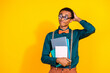 © deagreez - Photo portrait of pretty young male hold copybooks confused look empty space wear trendy suit outfit isolated on yellow color background