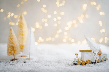 Wall Mural - christmas toy train travels through a miniature white snowy forest. minimalist festive christmas sce