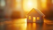 © monvideo - A glowing paper cutout of a house symbolizes real estate opportunities