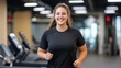 © Moopingz - A smiling woman exercises on a treadmill in a gym, promoting health, fitness, and an active lifestyle in a modern fitness center.