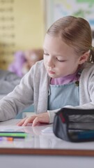 Poster - Girl, writing and test in classroom for education, thinking or problem solving for maths quiz at academy. Child, exam and assessment with solution, learning and development with progress at school