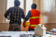 © thatinchan - A team of architects and engineers discuss with investors to design large scale construction projects that meet investors' needs and examine the feasibility of the project by expert architects.