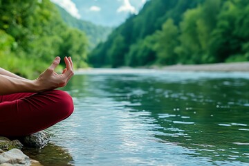 A person sitting by a calm river, with hands in a meditative pose, connecting to nature and inner peace