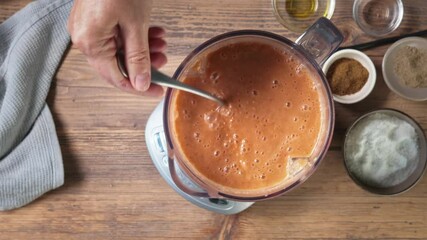 Sticker - Process of making gazpacho soup. Cook mixing and trying cold tomato soup in blender, top view