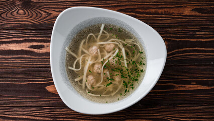 Wall Mural - Soup with noodles and chicken meatballs in a bowl.