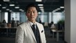 © Alteisen Riese - twenties asian man in white attire on office background model portrait looking confident for ad concept space for text