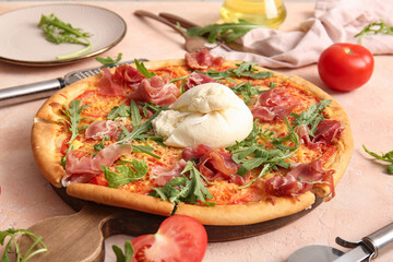 Wooden board of tasty pizza with Burrata cheese on beige background