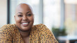 © Dirk - Bald plus size female office worker smiling; office environment; inclusive & diverse friendly workplace. Acceptance of diversity, body inclusive theme. Diversity themes poster concerning baldness, bea