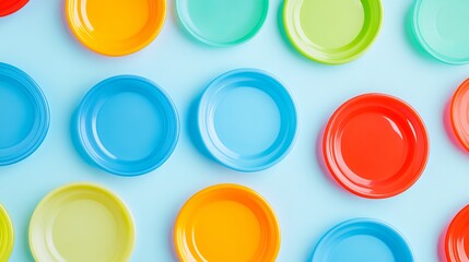 Flat lay image of colorful plastic frisbees on a light blue background, leaving ample space for text or branding. 