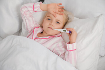 Sticker - Sick little girl with thermometer measuring temperature in bed