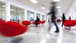 © Premium Graphics - Blurred wide shot of corporate office floor with minimalist furniture using a slow shutter speed to capture motion in a modern work setting