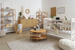 © Pixel-Shot - Interior of children's bedroom with crib, shelf units and baby monitor on table