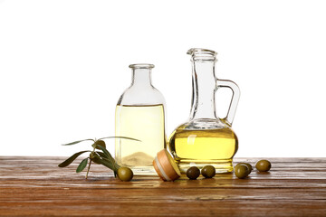 Wall Mural - Decanter and bottle of fresh olive oil on wooden table against white background