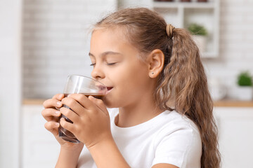 Wall Mural - Cute girl drinking sweet hot cocoa in kitchen