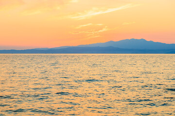 Wall Mural - The ocean is calm and the sky is orange