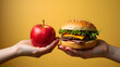 © Pukan - Choosing Between Healthy Apple and Tempting Burger on Yellow Background