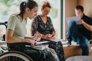 A diverse group engages in a collaborative session, featuring a woman in a wheelchair contributing ideas. The setting is informal and inclusive, highlighting teamwork and innovation.