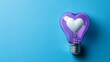 © Raitalinn - A purple heart-shaped light bulb shines brightly against a cool blue background.