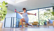 © Wavebreak Media - Exercising with dumbbells, plus size woman doing yoga in modern living room, at home