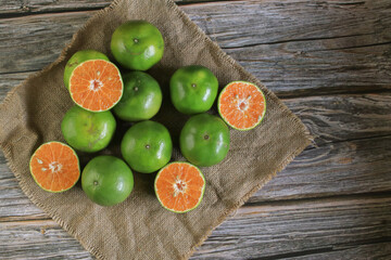 Fresh orange fruits on dark background. Citrus juicer. Summer tropical fruits. Food concept. Creative background 