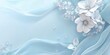 © AURA COLLECTIONS - A serene blue background with delicate white flowers and flowing fabric elements.