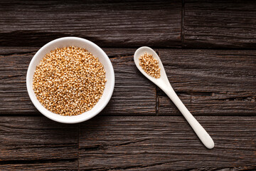 Canvas Print - Bowl and spoon with amaranth pops - Amaranthus. Green background